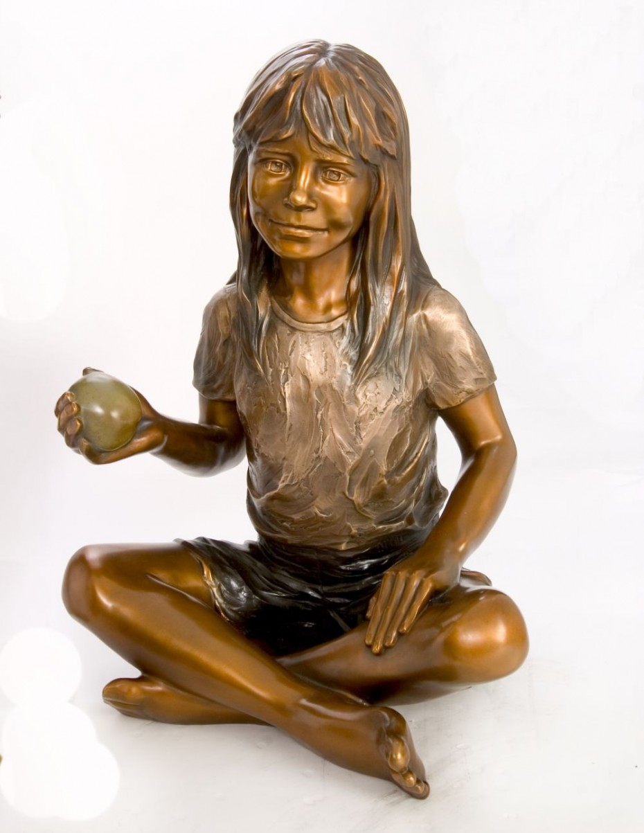 child bronze sculpture with apple
