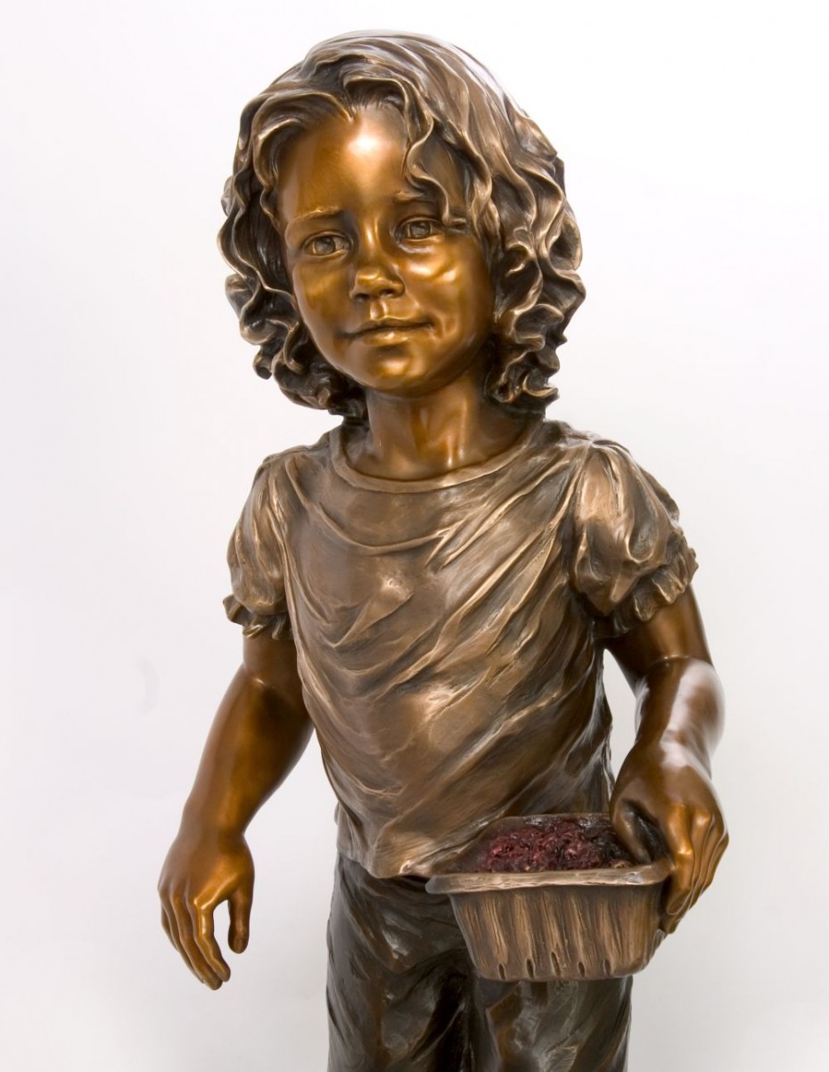 bronze child sculpture with raspberries